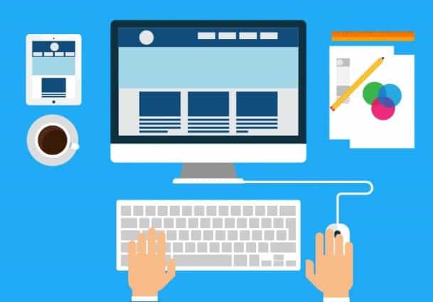 Flat design illustration of hands at a keyboard and mouse in front of a desktop monitor showing a website layout
