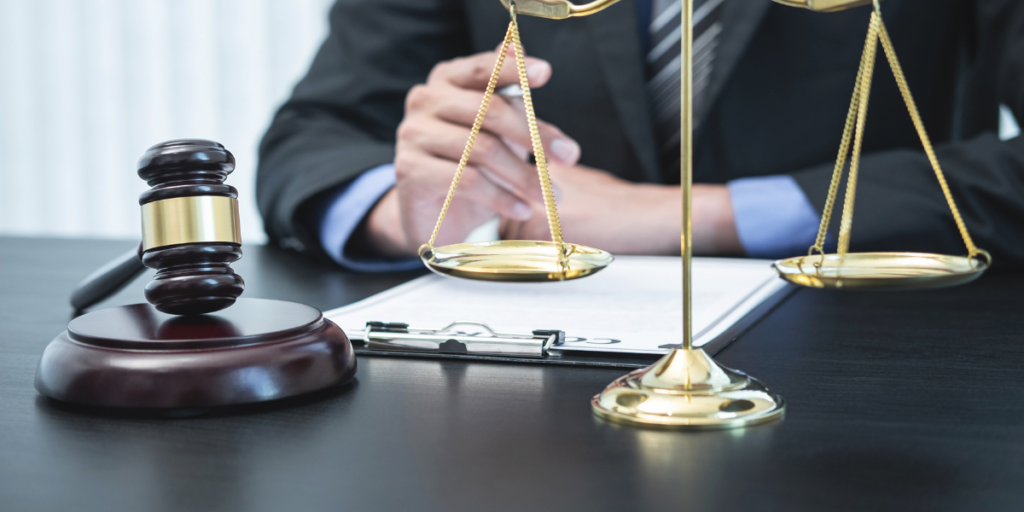 Lawyer with gavel and scales of justice reviewing documents, representing digital marketing for lawyers