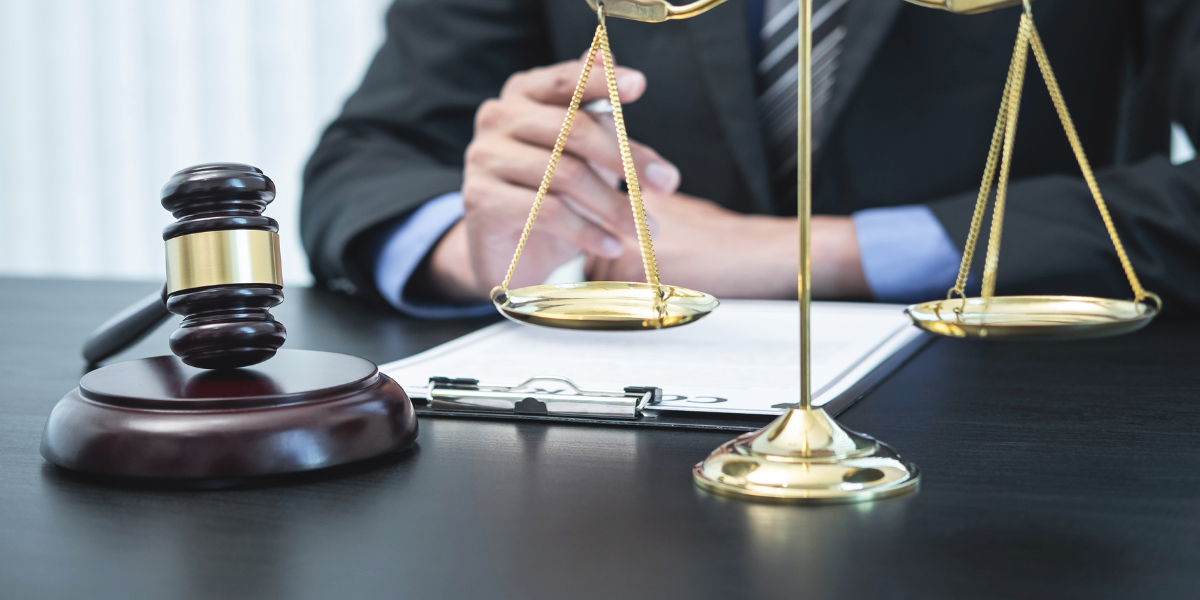 Lawyer with gavel and scales of justice reviewing documents, representing digital marketing for lawyers